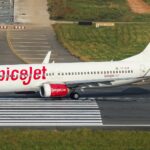 SpiceJet airplane taxiing on the runway at Dhaka Airport, Bangladesh.