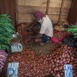 An elderly vendor selling vegetables at a market in Colombo, Sri Lanka.