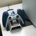 Close-up of a DualSense controller charging on a dock, perfect for gaming setups.