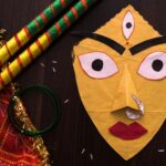 Colorful Navratri items, including Indian mask and dandiya sticks, on display.