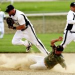 Dynamic baseball scene capturing players in action with a dramatic slide on the field.