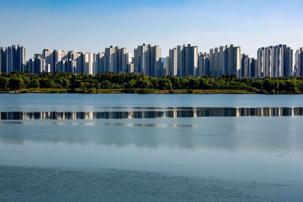 Skyline of modern residential towers reflecting in the peaceful Han River in Seoul, South Korea.
