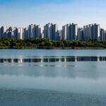 Skyline of modern residential towers reflecting in the peaceful Han River in Seoul, South Korea.