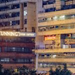 A captivating night view of Delhi's modern urban buildings illuminated by neon signs.