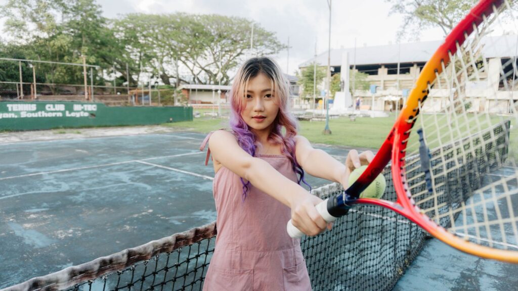 Young woman with tennis racket on an outdoor court in Southern Leyte.