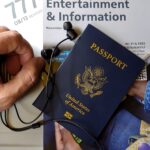 Close-up of US passport with inflight magazine and headphones on an airplane seat, ready for travel.