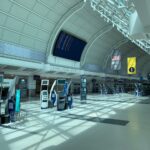 Creative design interior of contemporary airport with corridor under information board and signboards