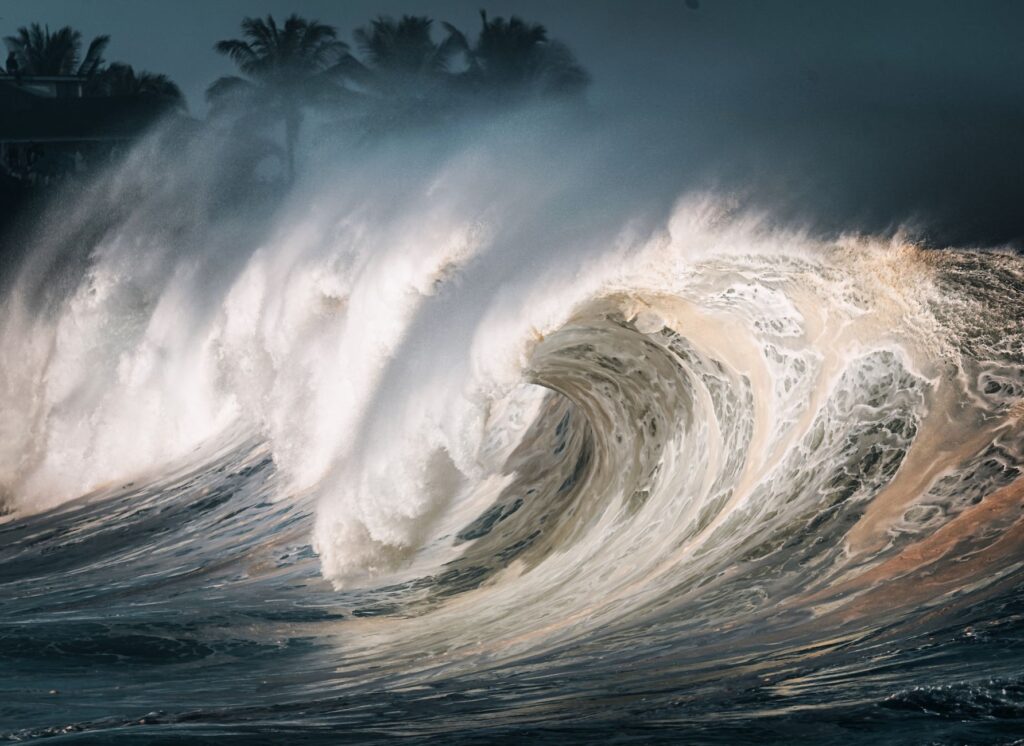 Captivating image of massive ocean waves breaking on the shore, creating a dramatic scene.