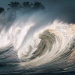 Captivating image of massive ocean waves breaking on the shore, creating a dramatic scene.