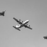 Black and white image of an Indian Air Force formation flight over New Delhi, India.