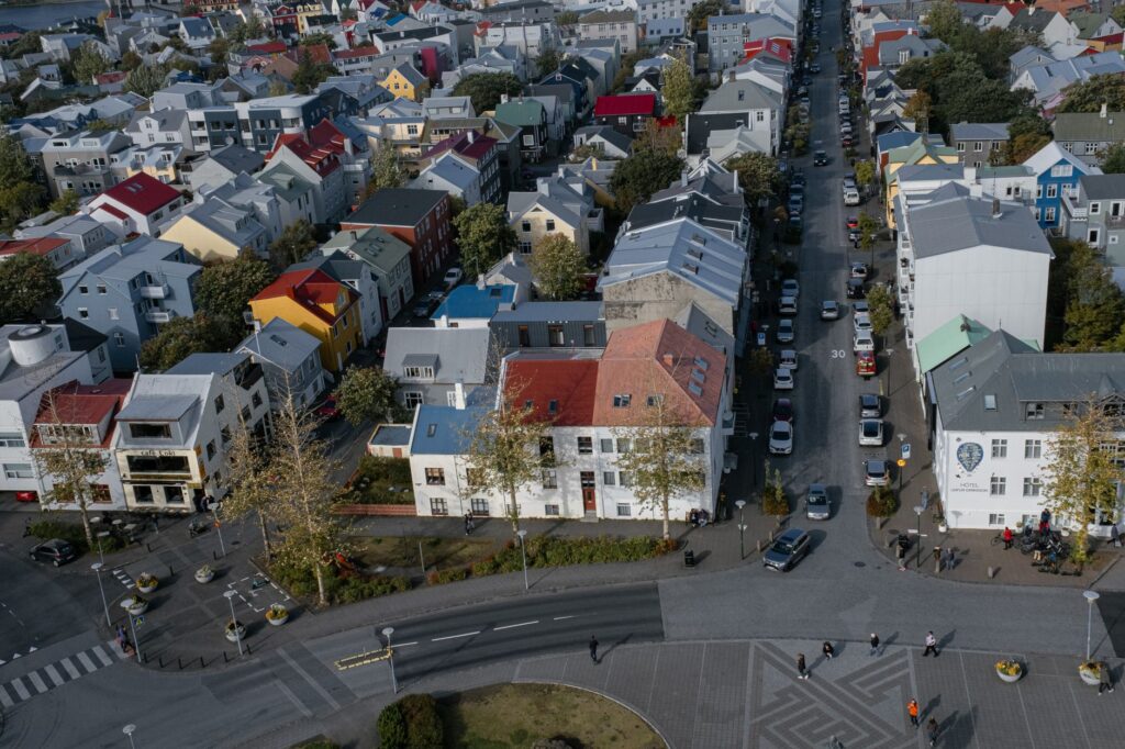Drone shot of colorful houses in Reykjavik, Iceland, showcasing urban residential architecture.