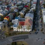 Drone shot of colorful houses in Reykjavik, Iceland, showcasing urban residential architecture.