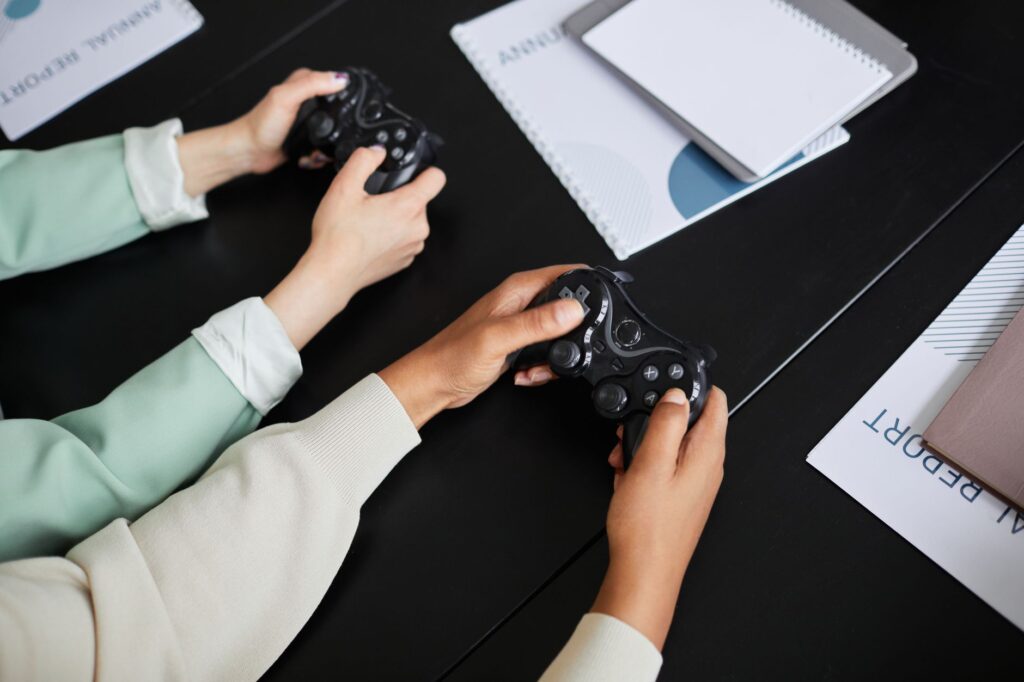 Two people playing video games with controllers, highlighting teamwork and gaming experience.