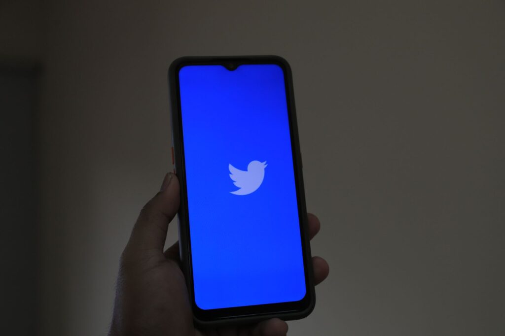A close-up of a smartphone displaying the Twitter app, emphasizing digital connection and modern technology.
