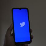 A close-up of a smartphone displaying the Twitter app, emphasizing digital connection and modern technology.