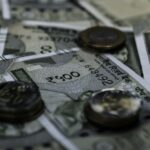 Detailed view of Indian currency notes and coins representing wealth and finance.