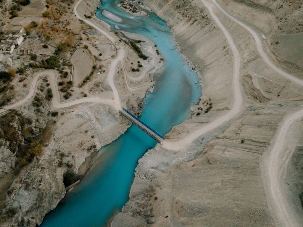 Breathtaking aerial shot of the winding Indus River through the arid mountains of Ladakh.