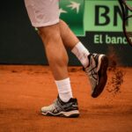 Close-up of a tennis player on a clay court in Montevideo, showcasing movement and energy.
