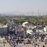 Aerial view of a large gathering at an outdoor marketplace in Mecca.