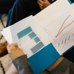 Detailed view of business reports with graphs during a corporate meeting.