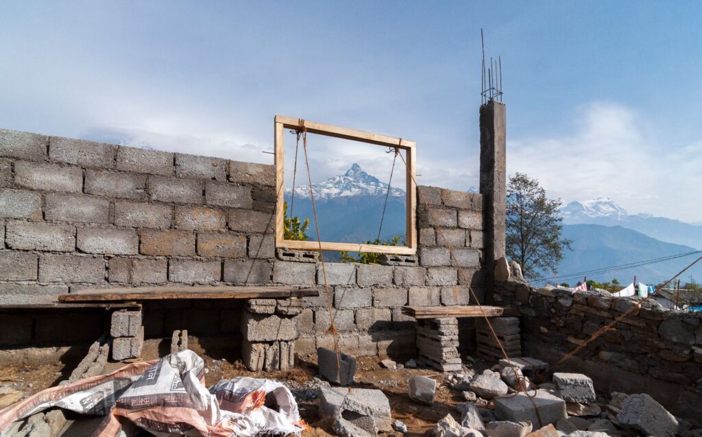 A construction site in Dhampus, Nepal, frames stunning view of Machhapuchhre peak.