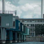 Colorful container homes on an urban waterfront showcasing modern architecture and industrial design.
