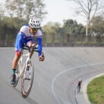 Cyclist in professional gear competing in a velodrome race in Lahore, Pakistan.