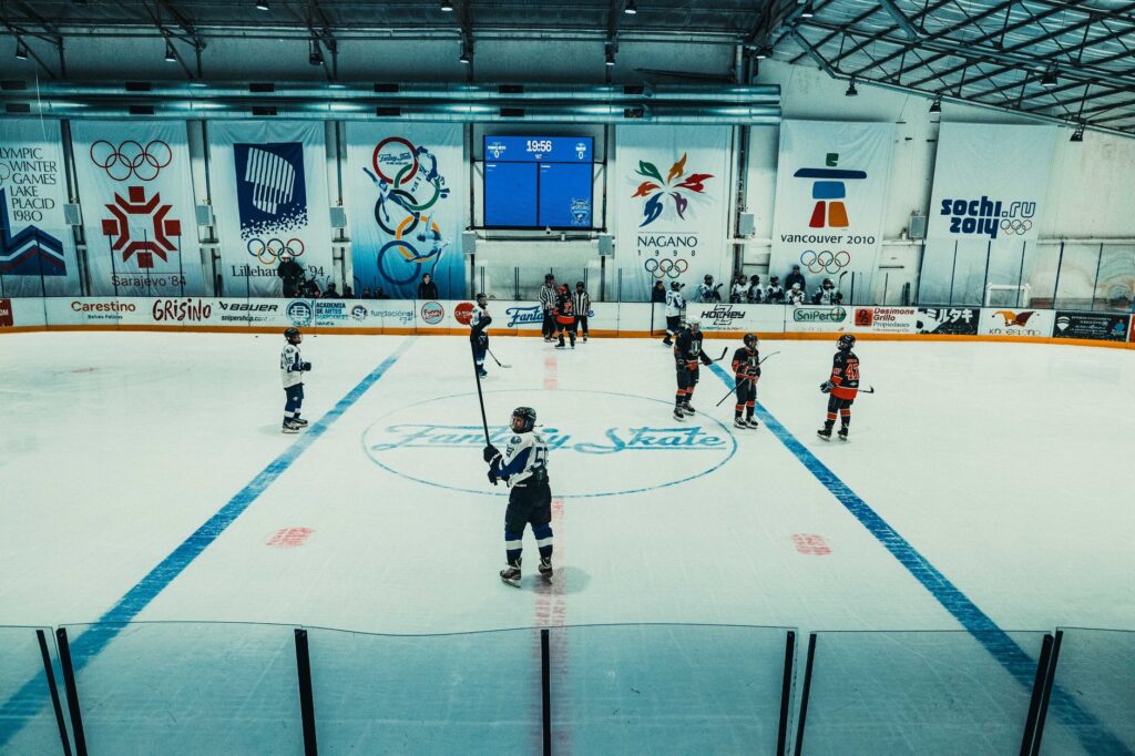 Indoor ice hockey game at the Olympic-themed arena in Buenos Aires with teams in action.