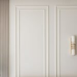 Minimalist wall design with a green plant and modern light fixture in a stylish room.