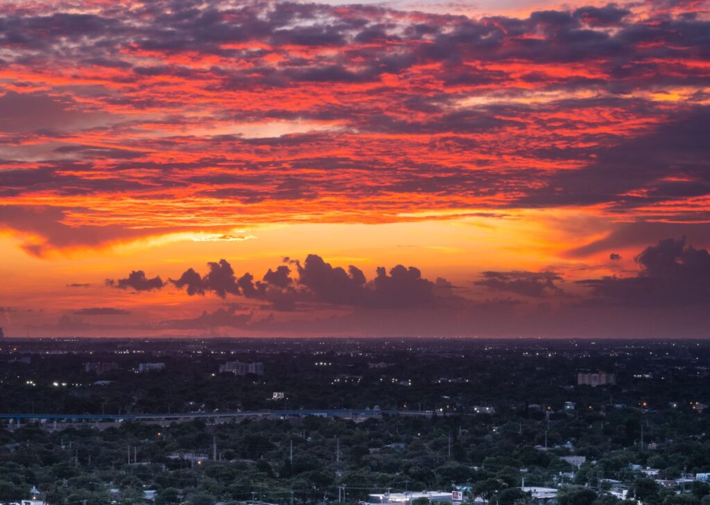 Breathtaking sunset over Miami skyline with dramatic clouds and vibrant colors.