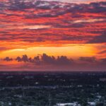 Breathtaking sunset over Miami skyline with dramatic clouds and vibrant colors.