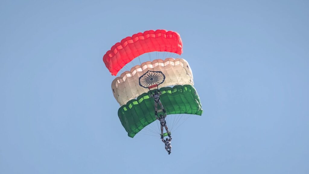 Skydivers displaying Indian flag colors in an aerial stunt in Bengaluru.