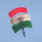 Skydivers displaying Indian flag colors in an aerial stunt in Bengaluru.