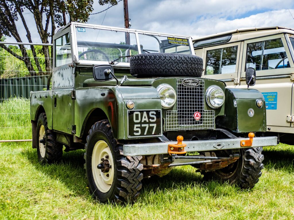 Vintage Land Rover Series vehicle parked outdoors, showcasing classic design.