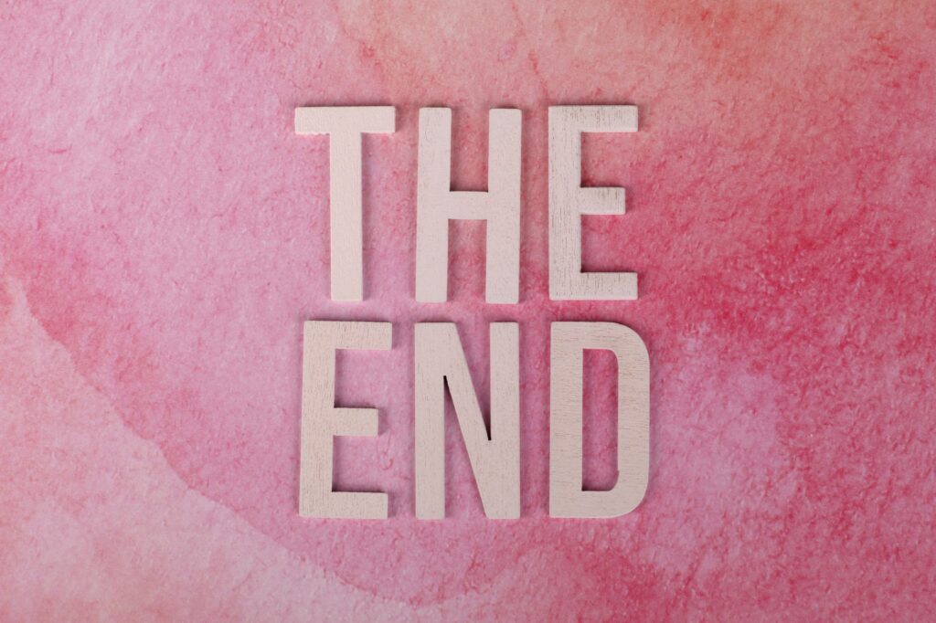Elegant 'The End' text on a textured pink background, perfect for closure or transition concepts.