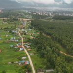 Scenic aerial view of rural Nepal with lush greenery and small villages.