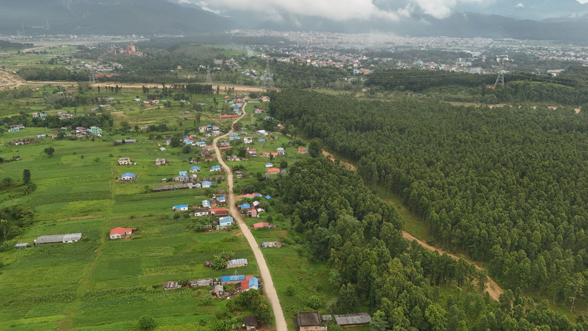 Scenic aerial view of rural Nepal with lush greenery and small villages.