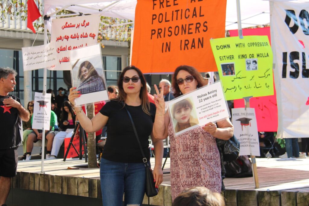 Participants at a Vancouver protest advocating for political prisoners in Iran hold banners and placards.