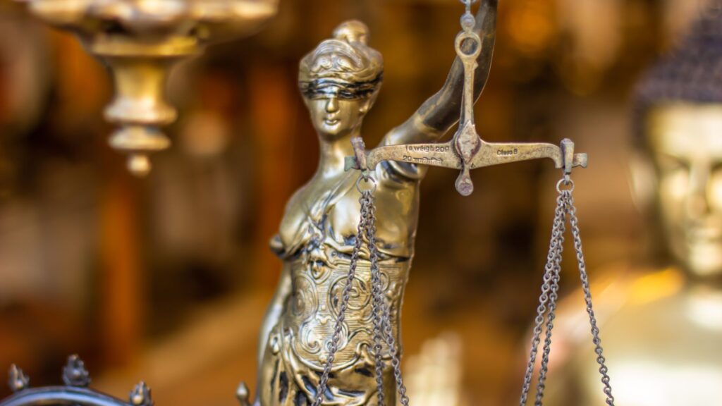 A detailed close-up of a Lady Justice statue holding scales, symbolizing law and justice.