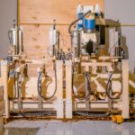 View of a complex woodworking machine in a factory setting, showcasing precision engineering and technology.