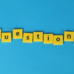 Yellow letter tiles spell 'questions' on a contrasting blue background.