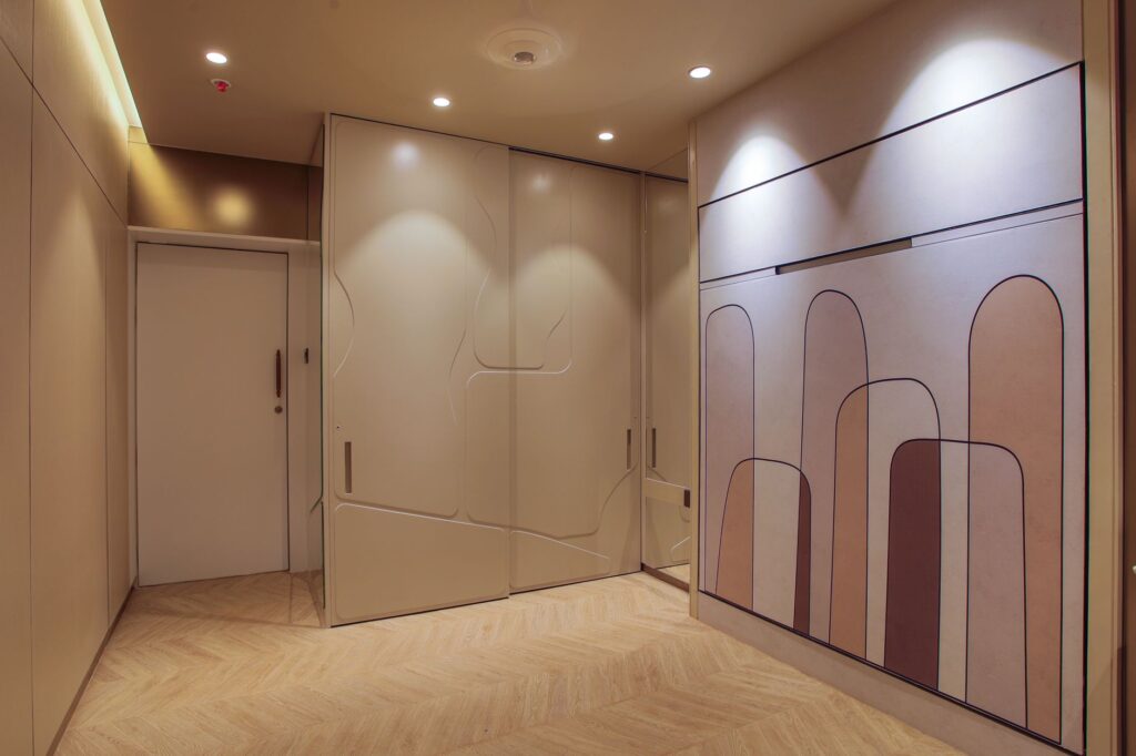 Illuminated hallway in a modern apartment with stylish wall panels and decor.