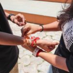 Close-up of a brother and sister participating in Raksha Bandhan, a traditional Indian festival.