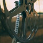 Artistic shot of a vintage film reel with soft light creating a nostalgic atmosphere.