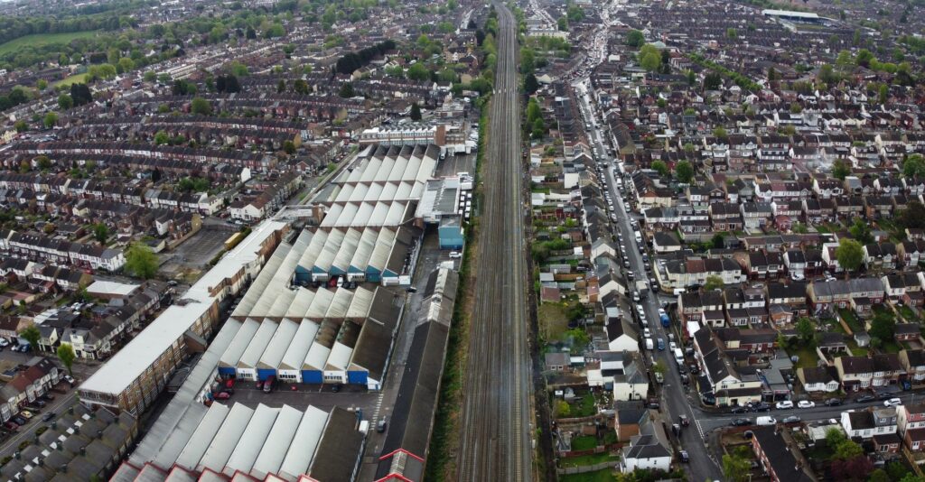 Aerial view of houses and train tracks in Maidenhall, illustrating urban and suburban architecture.