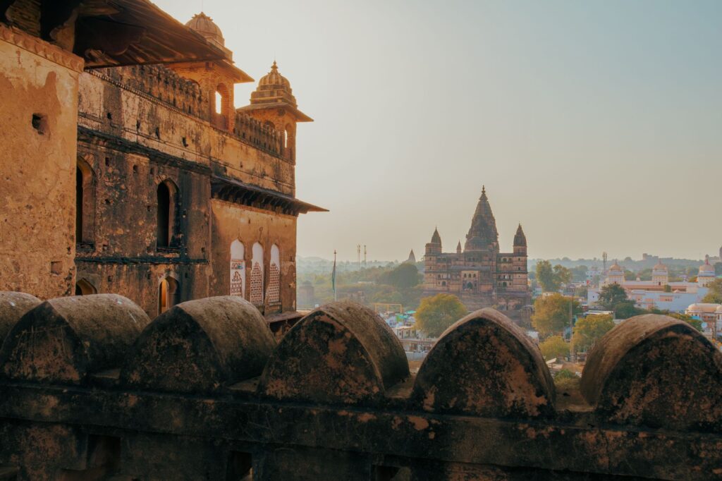 Captivating view of Orchha's ancient temples and fort, showcasing Rajput architecture at sunrise in Madhya Pradesh, India.