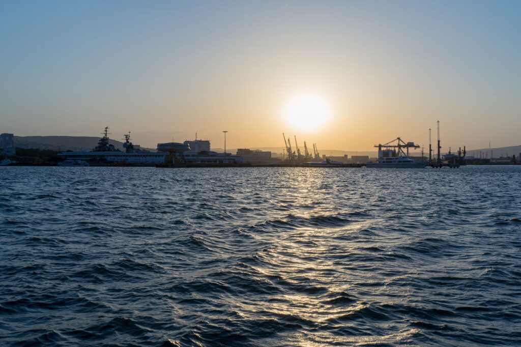 Beautiful sunset view over the harbor of Novorossiysk, showcasing the vibrant sea and skyline.