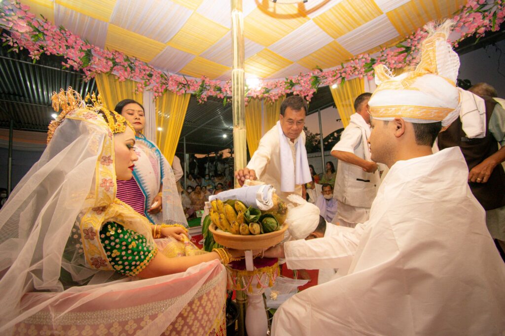 A colorful traditional wedding ceremony in Kanglatongbi, India with cultural attire.
