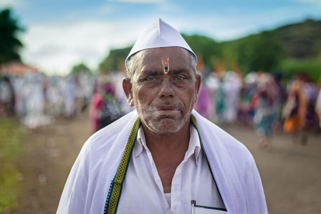 A close-up of a pilgrim at a vibrant religious gathering in Pandharpur.