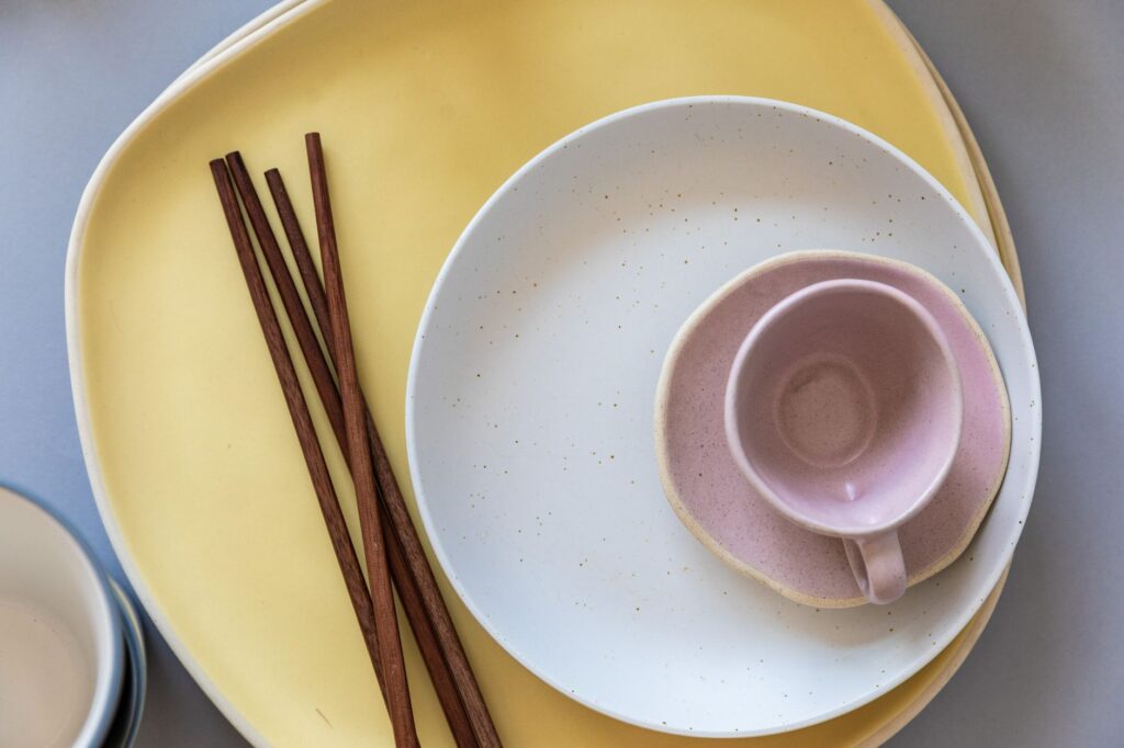Flat lay of ceramic plates and chopsticks showcasing modern minimalist design.
